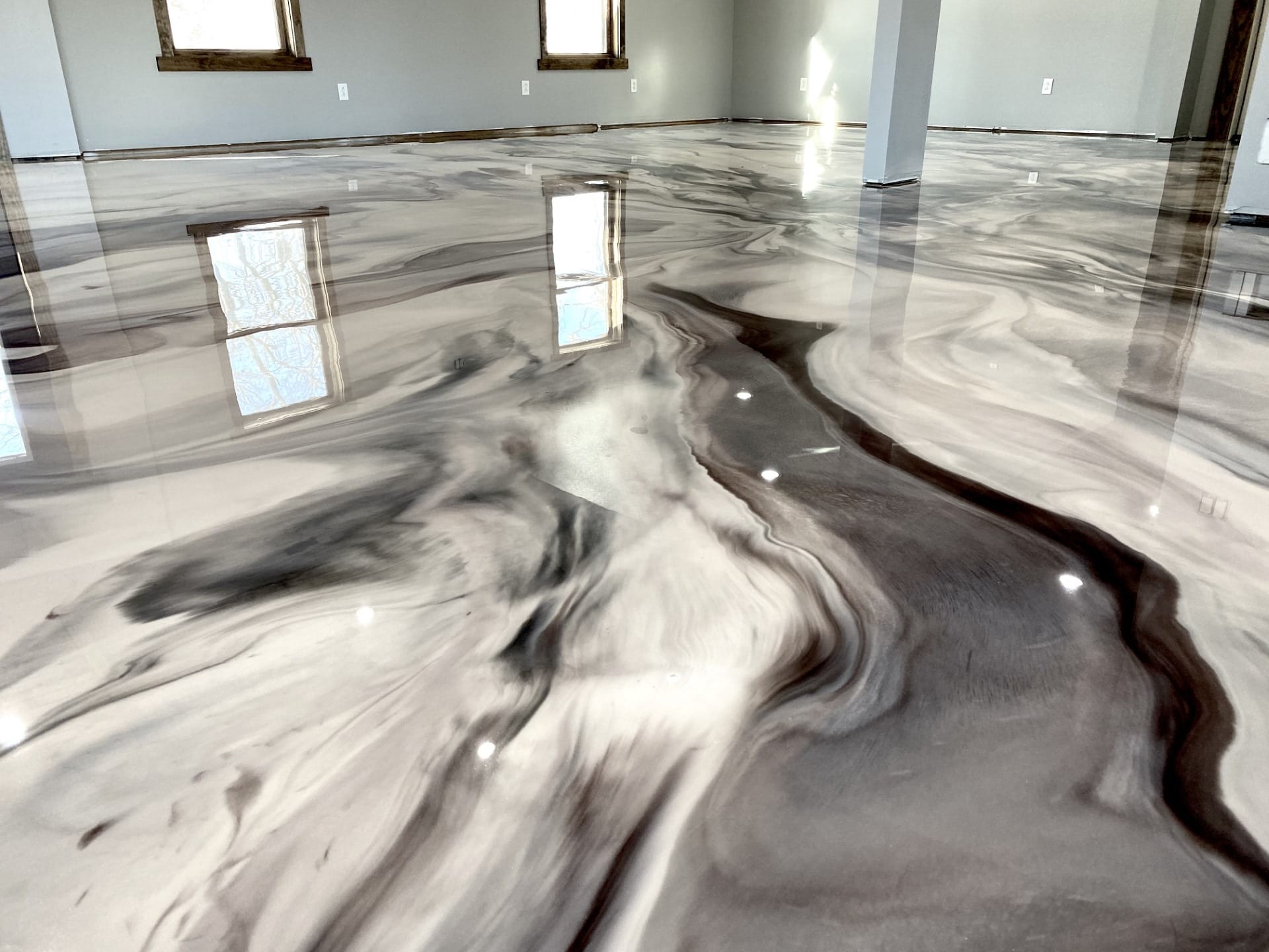 Luxury gray and white metallic epoxy floor with marble-inspired movement and glossy finish